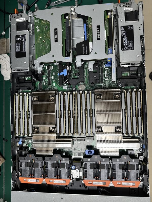 Inside a Dell PowerEdge R670 showing dual CPU sockets, DDR5 memory banks and cooling fans, actual unit