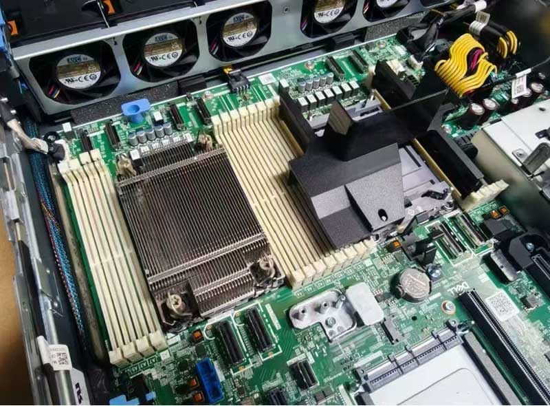 Inside a Dell PowerEdge R760xs showing cooling fans, CPU heatsink and mainboard, actual unit